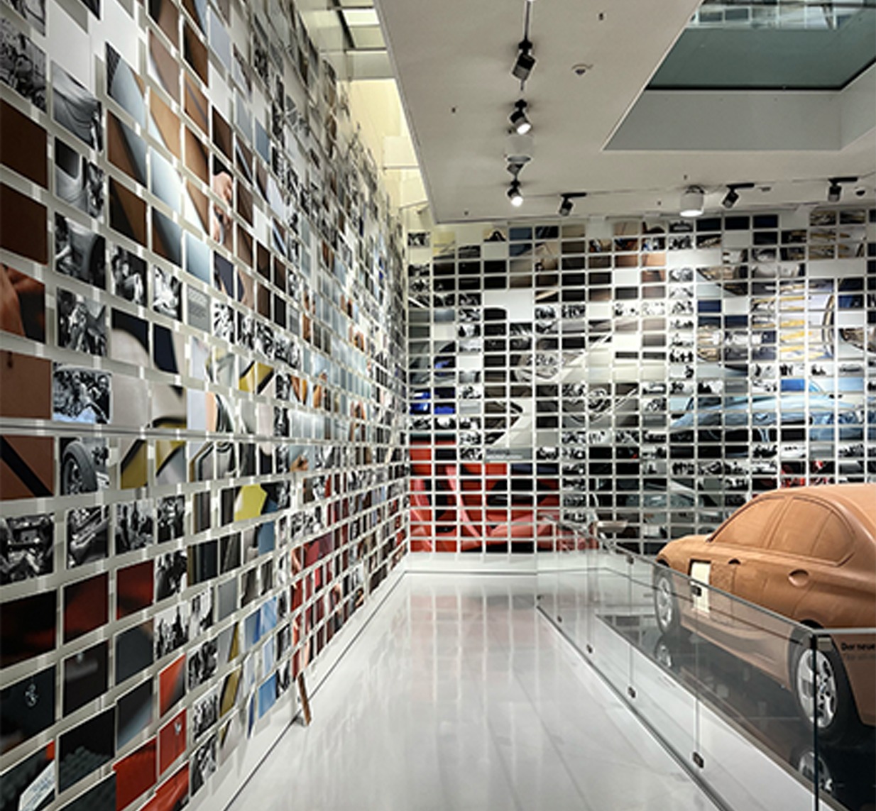 BMW museum archive wall of photographs beside a concept car