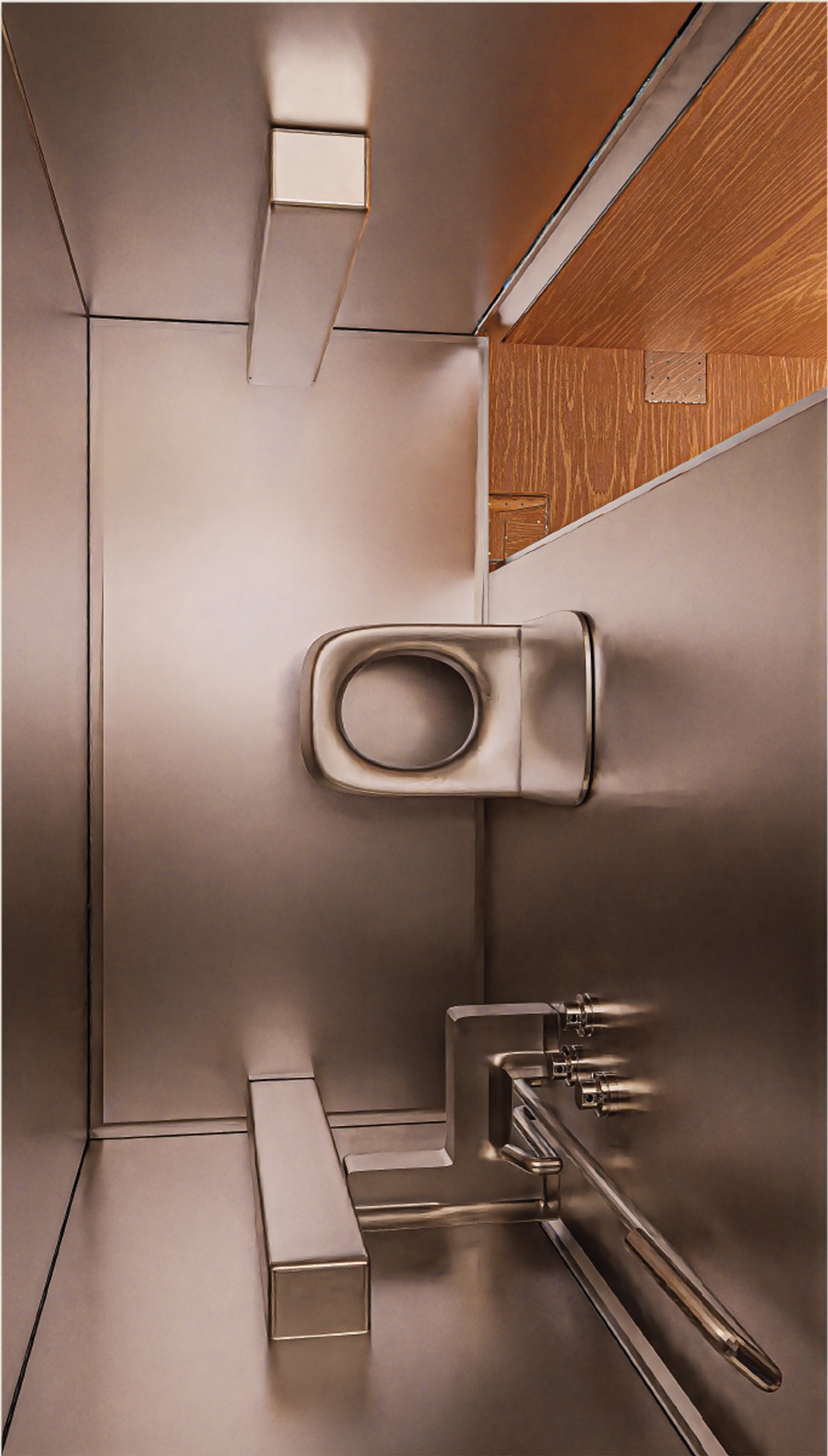 Brushed metal interior detail of the pod's compact wet room