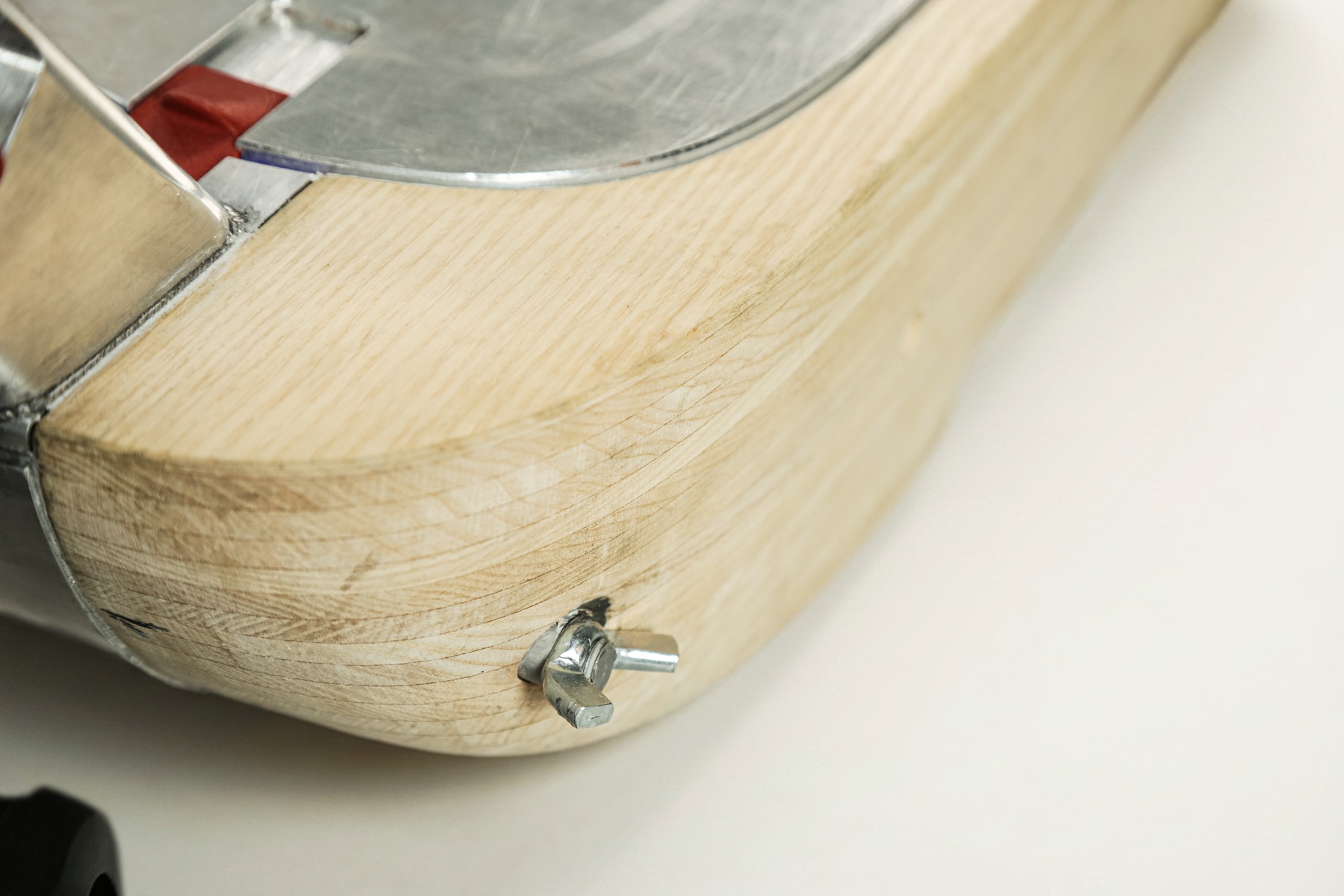 Close detail of the wooden deck's rounded corner and mounting screw