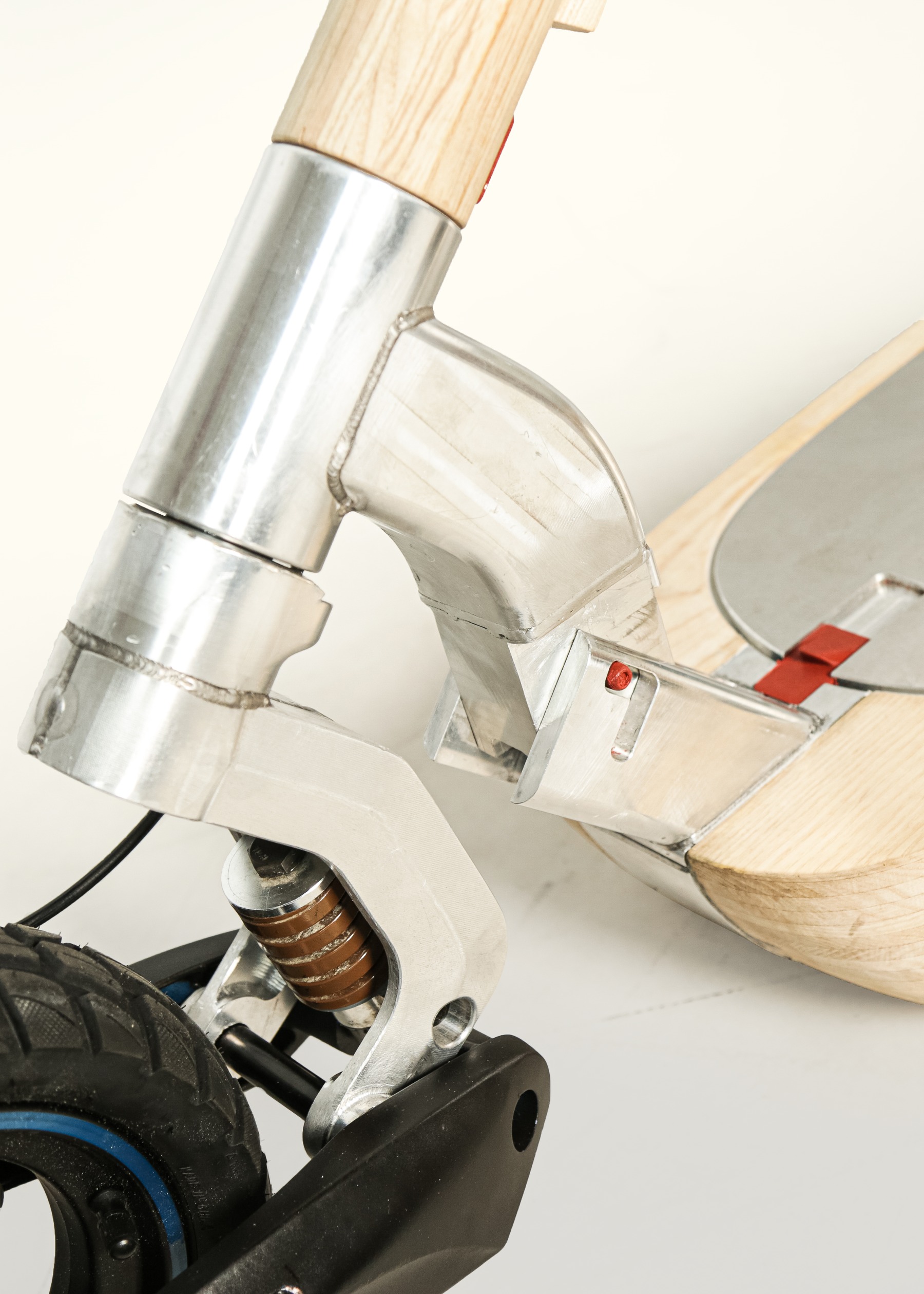 Neck joint folding against the deck with the front wheel visible