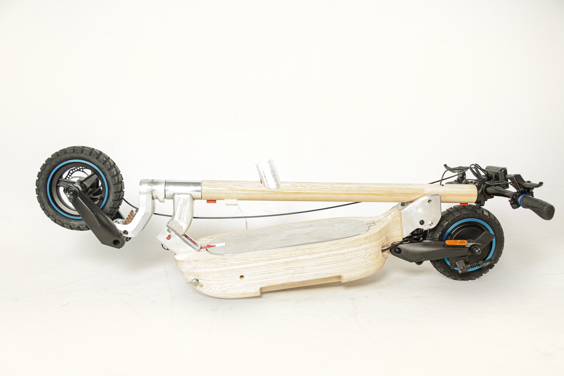 Scooter fully folded, side view on a white studio background