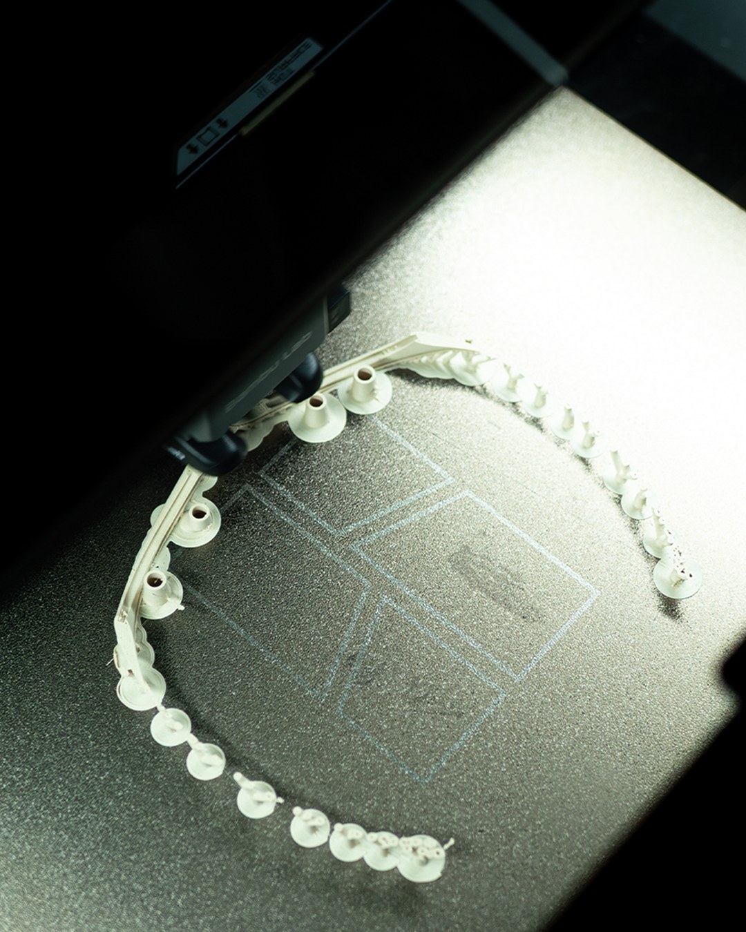 Physical prototype being 3D printed, hinge lattice forming on the build plate