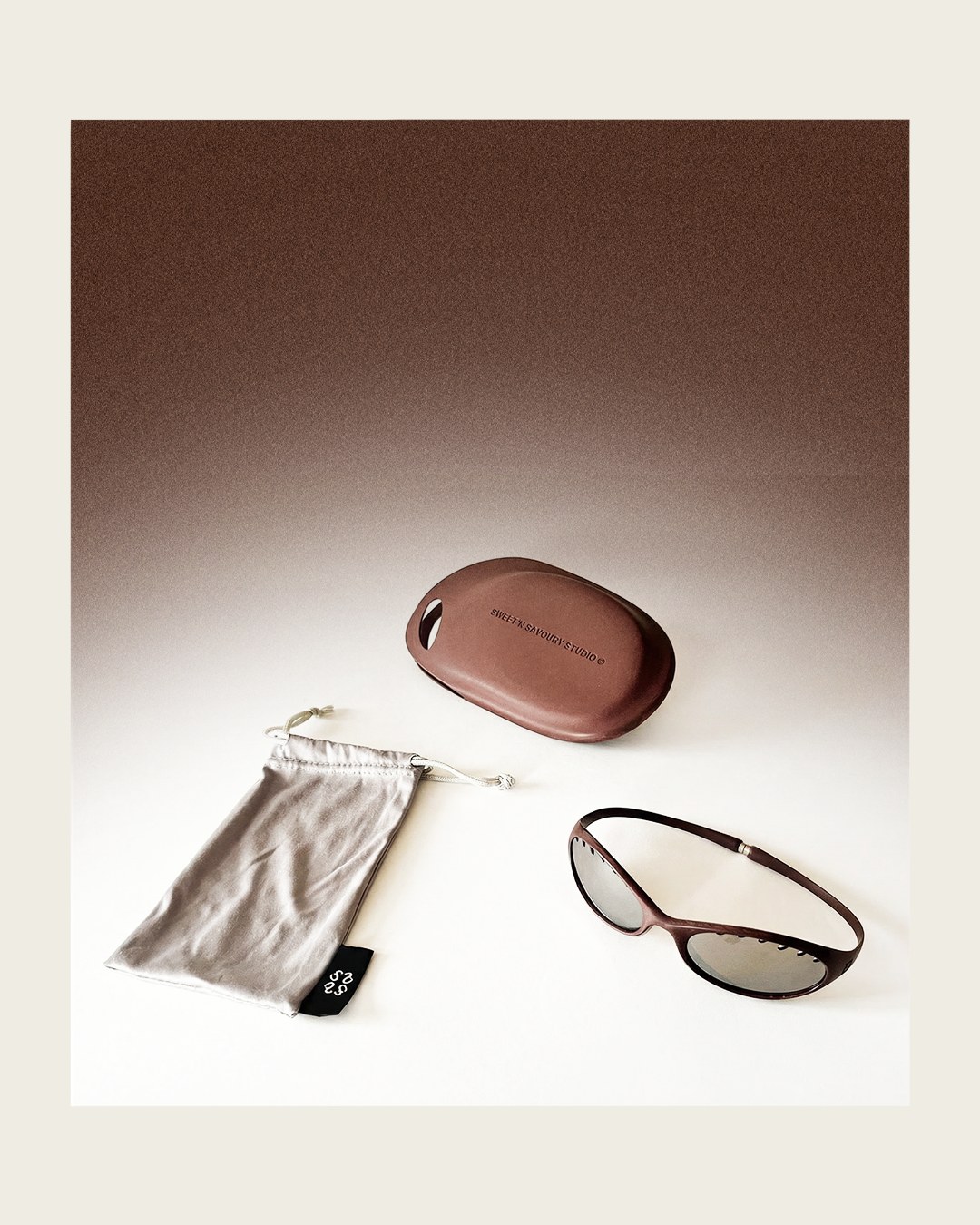 Frame, pouch and case in a brown colourway on a gradient studio background