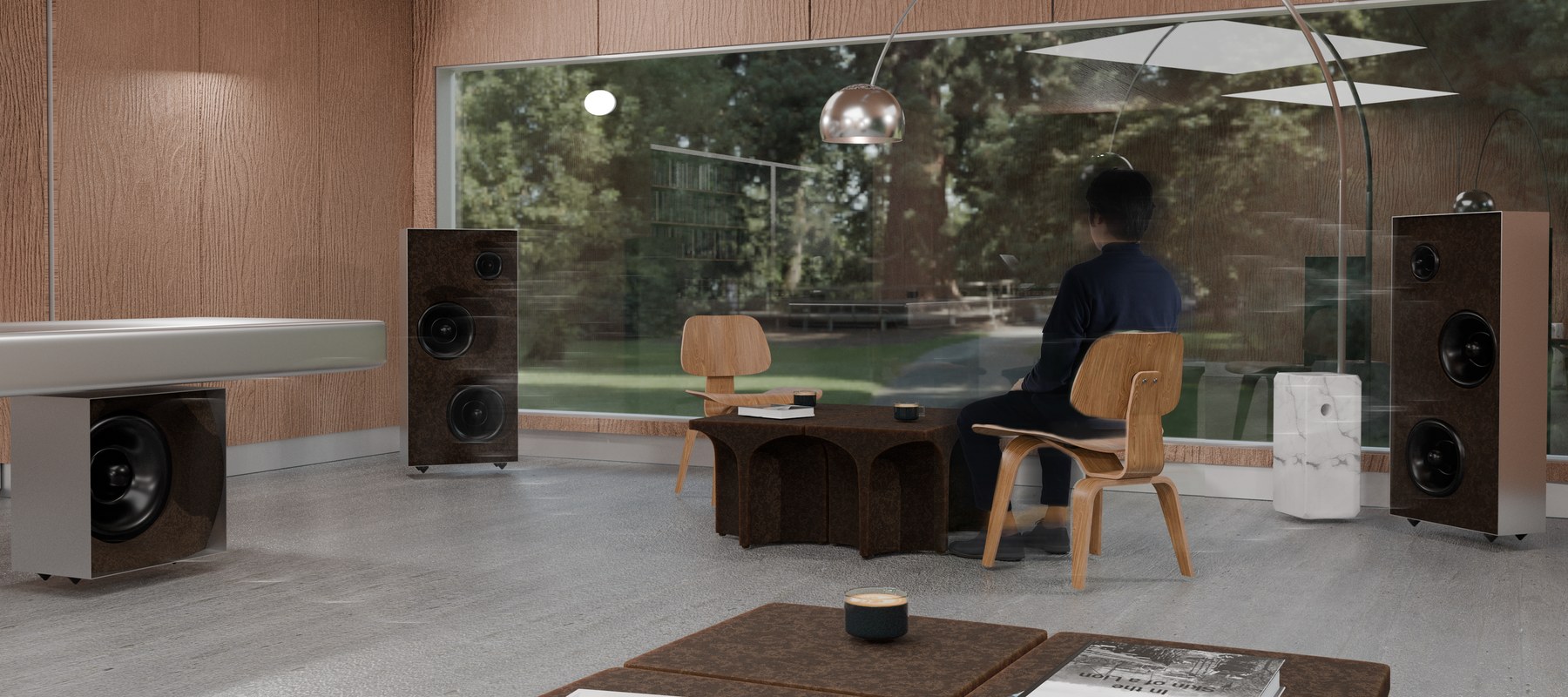 Groundwave speakers in a glass-walled lounge overlooking the garden