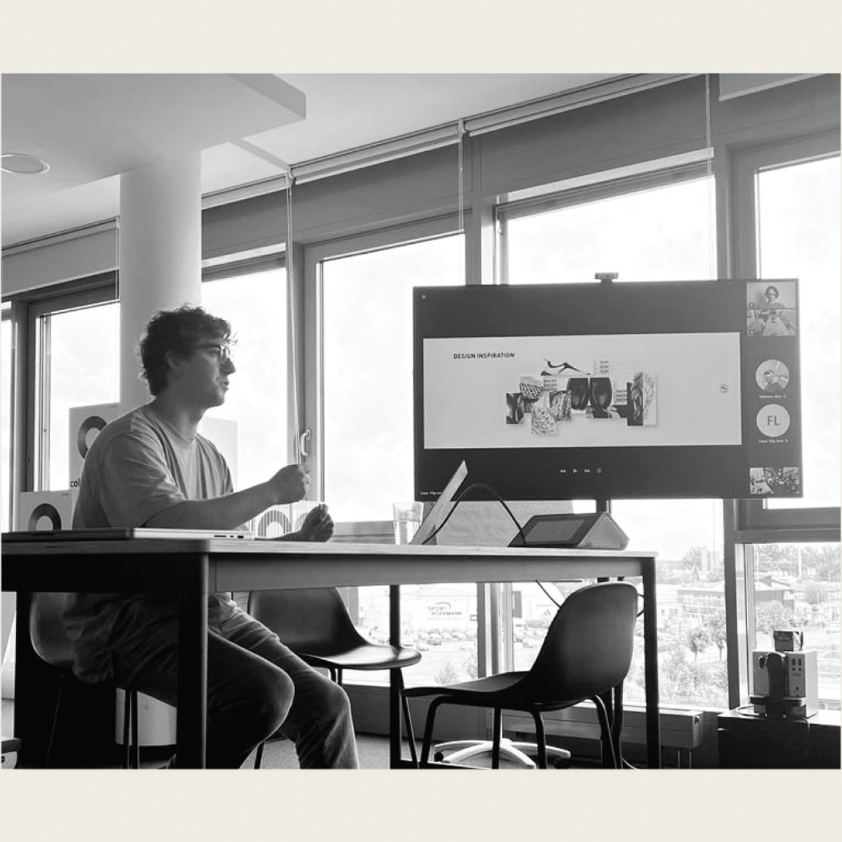 Working at a desk, reviewing the design presentation on screen