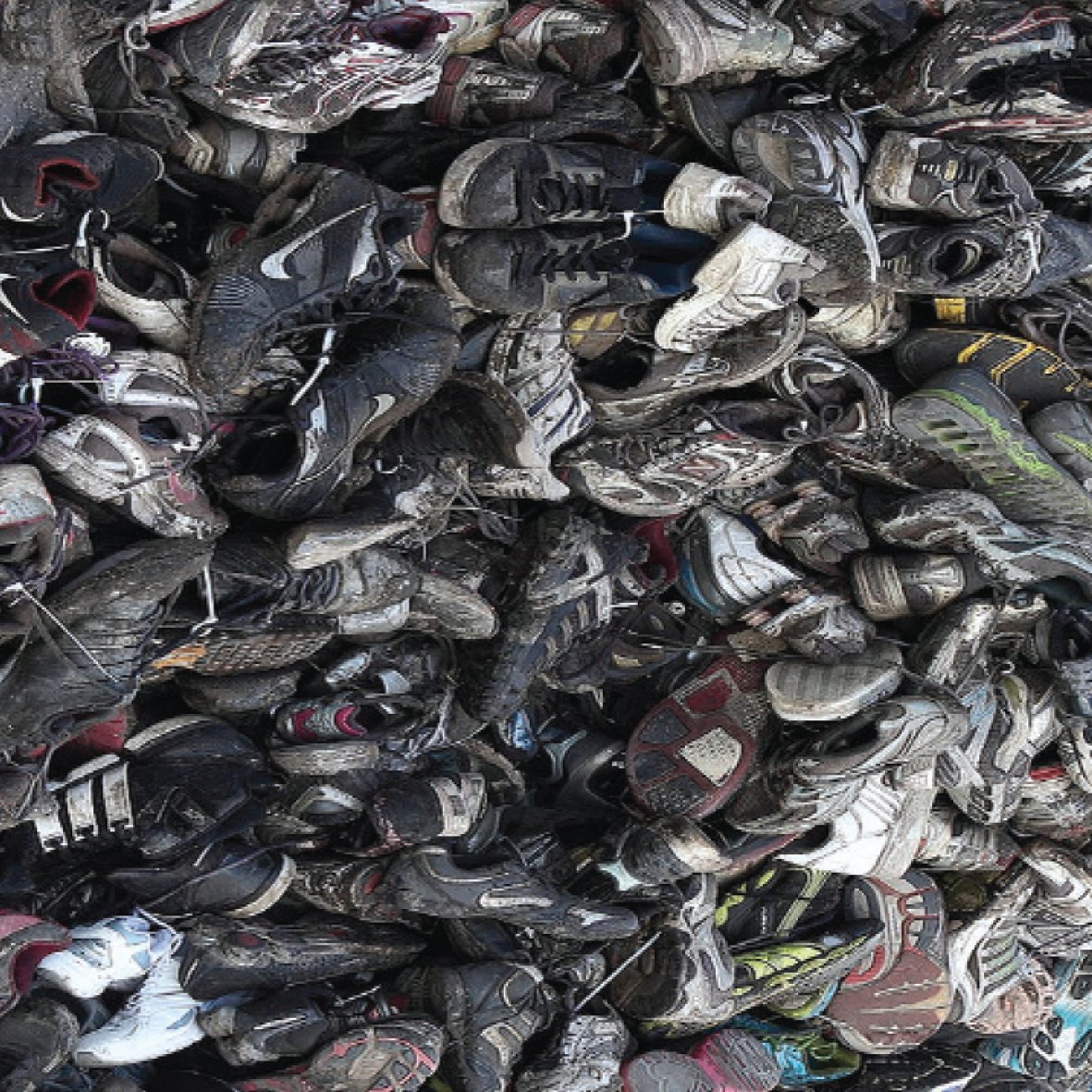 Pile of discarded shoes, circularity and waste-material reference